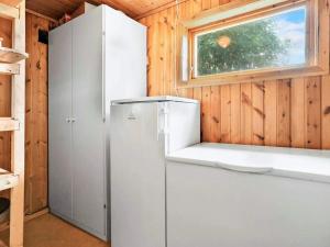 a white refrigerator in a room with a window at 8 person holiday home in Stavang in Stavang +16 photos