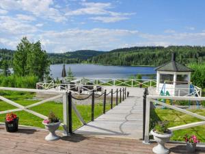 a wooden boardwalk with a gazebo and a lake at 4 star holiday home in KIL in Kil