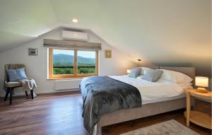 a bedroom with a large bed and a window at Gorgeous Home In Stubicke Toplice in Stubicke Toplice