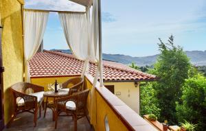 a balcony with a table and chairs and a view at 3 Bedroom Cozy Home In Camaiore in Camaiore