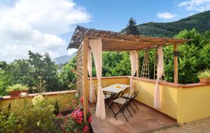 a patio with a table and chairs on a deck at 3 Bedroom Cozy Home In Camaiore in Camaiore