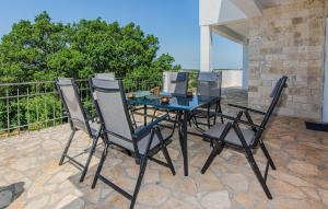 a table and four chairs on a patio at Gorgeous Home In Popovici With Wifi in Popović
