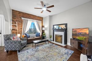 a living room with a couch and a fireplace at Walkable Historic District Riverview Escape in Jeffersonville
