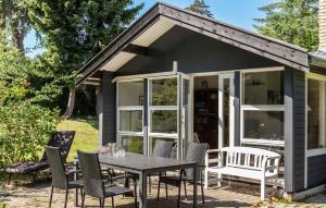 a small shed with a table and chairs at Nice Home In Vejby With Kitchen in Vejby