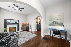 a living room with a couch and a fireplace at Stylish Home in Historic District Near Riverwalk in Jeffersonville +96 photos