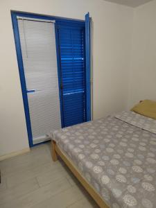 a bedroom with a bed and a blue door at Apartman Dadi in Igalo