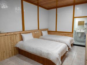 Postel nebo postele na pokoji v ubytování Chang Qing Ju Homestay
