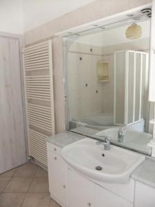 a bathroom with a sink and a tub and a mirror at Hotel Paradise in Bruzolo +41 photos
