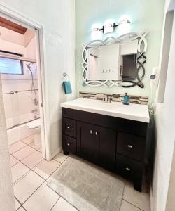 a bathroom with a sink and a mirror at Kihei Resort 221 condo in Kihei +20 photos