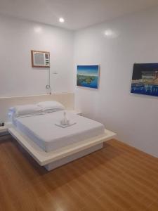 a bedroom with a white bed in a room at Campoquino Beach Resort in Sipalay