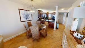 a dining room and living room with a table and chairs at Destin on the Gulf 701 in Destin