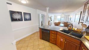 a kitchen with a sink and a counter at Destin on the Gulf 701 in Destin
