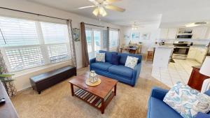 a living room with a blue couch and a table at Islander Beach Resort 6007 in Fort Walton Beach
