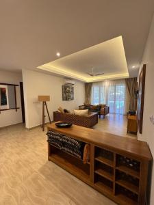 a living room with a couch and a table at beachfront hideaway 1bed with pool&ac in Diani Beach
