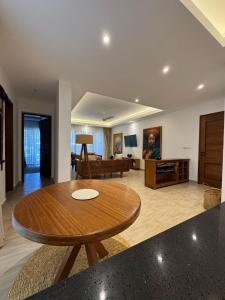 a living room with a wooden table and a couch at beachfront hideaway 1bed with pool&ac in Diani Beach