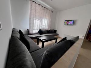 a living room with a couch and a table at Abdu house in Oulad Akkou