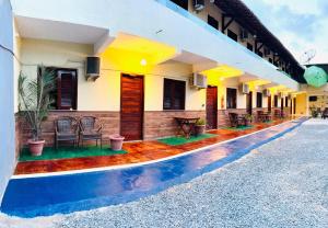 a building with a colorful floor in front of it at Hotel Pinto Martins in Camocim