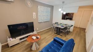 a living room with a blue couch and a table at Klasse Villa Miyako in Miyako-jima