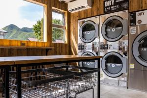 a bunch of washing machines in a laundry room at IkazawaYumotokan in Minami Uonuma +30 photos