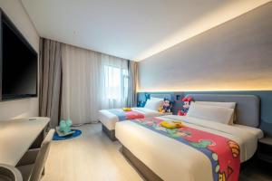 a hotel room with two beds and a flat screen tv at Atour Light Hotel Guangzhou Panyu Hanxi Changlong-Free Midnight Snack&16 minutes drive to Conton Fair&Free Coffee Togo&Free Laundry and Drying services in Guangzhou