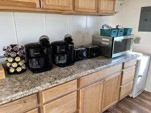 a kitchen counter with a coffee maker and a microwave at Yellowstone Dreamin Camp in Emigrant