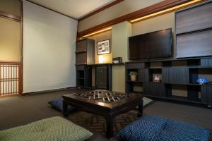 a living room with a coffee table and a flat screen tv at Hotel HERMIT in Takamatsu