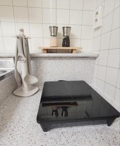a counter in a kitchen with a glass counter top at MISO Stay in Seoul