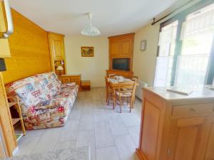 a living room with a couch and a table at Appartement confortable avec terrasse et Wi-Fi aux Rousses - FR-1-834-1 in Les Rousses