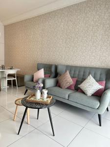a living room with a couch and a table at The Platino 6 to 8pax 2 carpark with Nextflix 5min to Paradigm in Johor Bahru