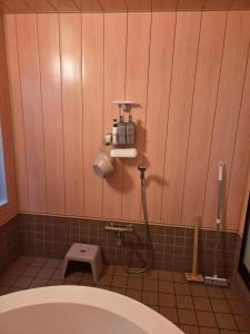 a bathroom with a shower and a toilet in it at 熱海網代くす亭 in Atami +38 photos
