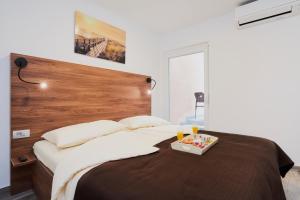 Postel nebo postele na pokoji v ubytování Apartments Tre Perle