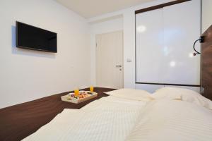 Postel nebo postele na pokoji v ubytování Apartments Tre Perle