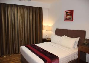 a hotel room with a bed and a window at Imperial Heritage Hotel Melaka I City Centre I Free Wifi I Free Parking l Free Club Lounge Access in Melaka