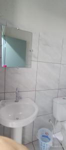 a bathroom with a sink and a toilet and a mirror at A M Hotel in São Luís +9 photos