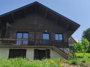 una grande casa in legno con balcone di Chalet rénové pour 12 pers. à Super Besse - FR-1-814-89 a Besse-et-Saint-Anastaise