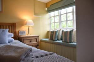 a bedroom with a bed and a window at The Dolphin Inn in Thorpeness