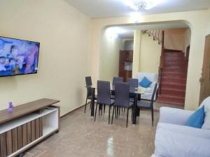 a living room with a dining room table and chairs at Beautiful cozy house in Arequipa
