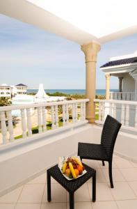 a tray of fruit on a table on a balcony at Royal Tulip Taj Sultan in Hammamet