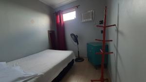 a small room with a bed and a window at Yamara's somente mulheres in Manaus +6 photos