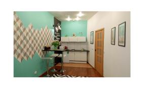 a room with a kitchen with a table in it at Griboyedova-nab-2b in Saint Petersburg