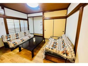 a living room with two couches and a table at Kanae - Vacation STAY 96254v in Tateyama