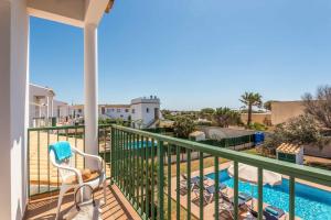 a balcony with a view of a swimming pool at Villa Aguasol in Cala en Forcat