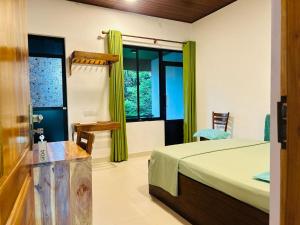 a bedroom with a bed and a window at Aura Home Stay in Batticaloa