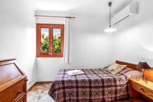 a bedroom with a bed and a window at Villa Voltor Cinco in Pollença +16 photos