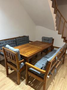 a dining room with a wooden table and chairs at Casa Livia in Tuzla