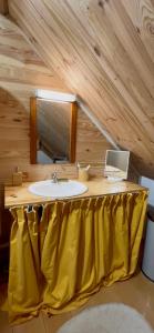 a bathroom with a sink and a mirror at L'abri de rioumaou in Saligos