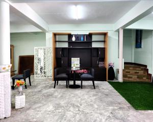 a living room with a table and chairs in a room at 55 Hostel Soi Phetkasem 51 in Ban Tambon Bang Khae +45 photos