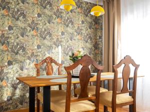 a dining room with a table and chairs with a wall at Casa Camilo Retro with Charm in Santander +44 photos