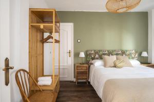 a bedroom with a large white bed and a ladder at Casa Camilo Retro with Charm in Santander