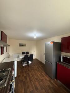 a kitchen with a refrigerator and a table with chairs at The Olive Villa in Manchester +27 photos